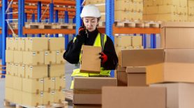 woman scanning and stacking boxes