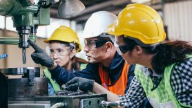 employees being shown how to do a task safely