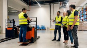 man teaching others how to use a forklift