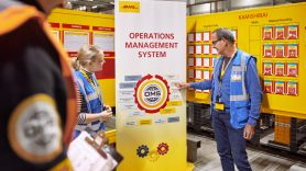 employees being taught with DHL posters and infographics