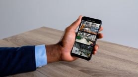 man watching security camera from his mobile phone