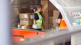 lady loading parcels in hard hat 