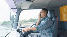 tired man driving a truck