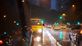 DHL van in traffic in the rain