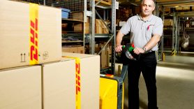 man pushing DHL boxes