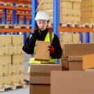 woman scanning and stacking boxes