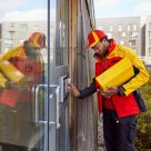 man delivery parcel to building