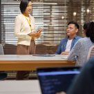 people in meeting room in office