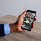 man watching security camera from his mobile phone