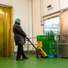 person moving items out of fridge