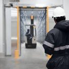 man watching man check warehouse on a forklift