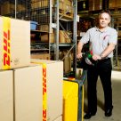 man pushing DHL boxes