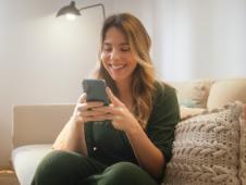 Woman shops via her cell phone