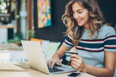 Woman makes a payment on a laptop