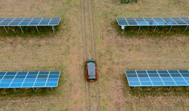 electric car between solar panels