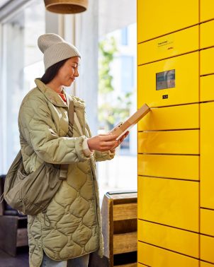 Woman picks up parcel at Parcel Locker