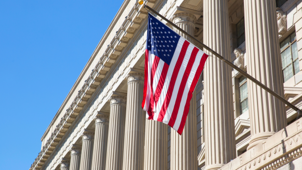 American flag flies in front of government building