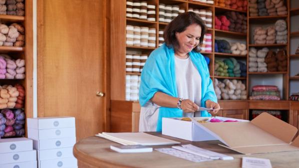 Employee of an sme packs goods for dispatch