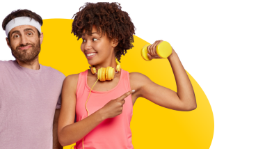 Man and woman in gym outfit, woman is displaying her fitness to the man by raising a weight.