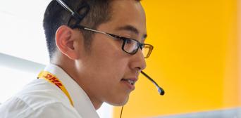 A DHL service operator talking into a  headset