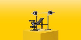 A weightlifting bench and equipment on a plinth