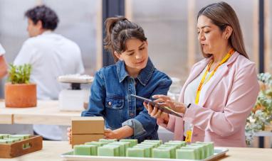 Woman with tablet explaining to another woman