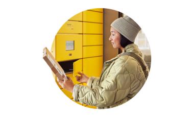 Woman picks up a parcel from a Parcel Locker