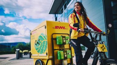 Female DHL delivery driver on an electric delivery bike 