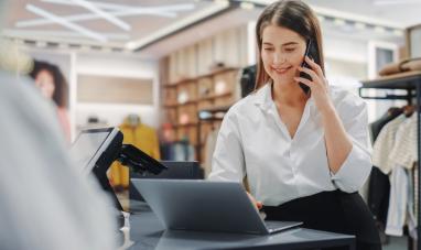 Woman working with phone and laptop