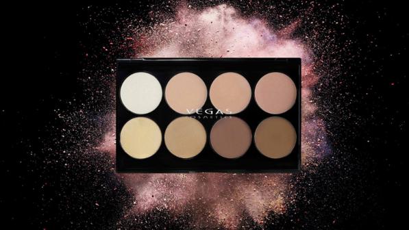 Eyeshadow pallet of various neutral shades on a black background with the company logo