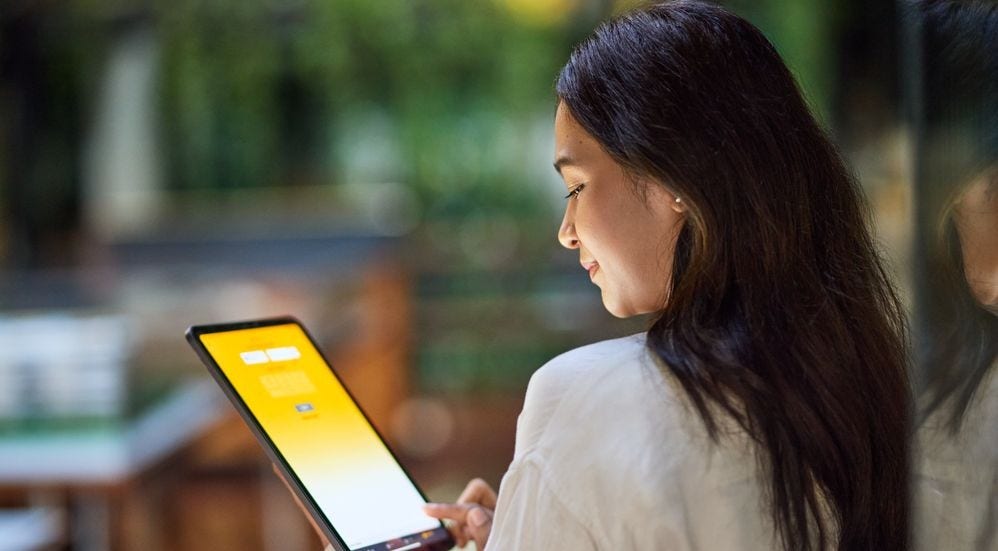 dhl express employee looking at tablet