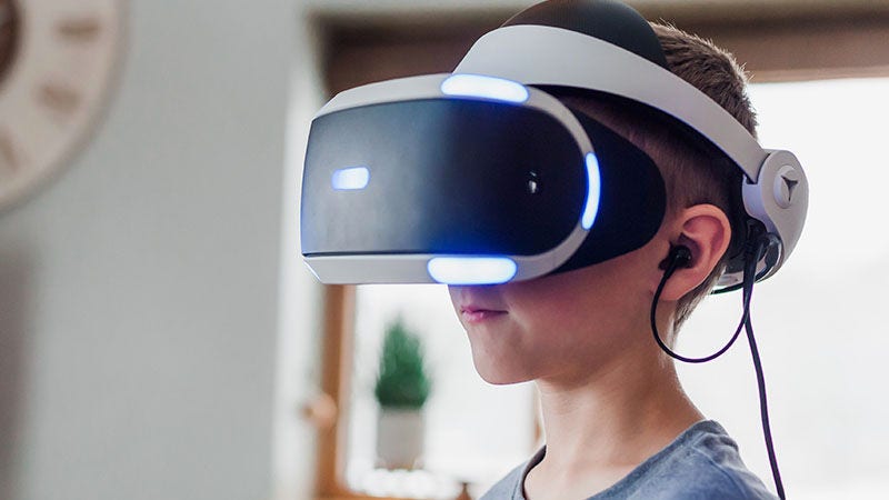 boy looking through VR glasses