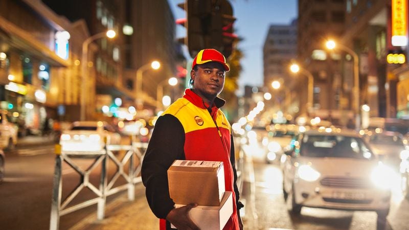 dhl express courier delivering a package in the city