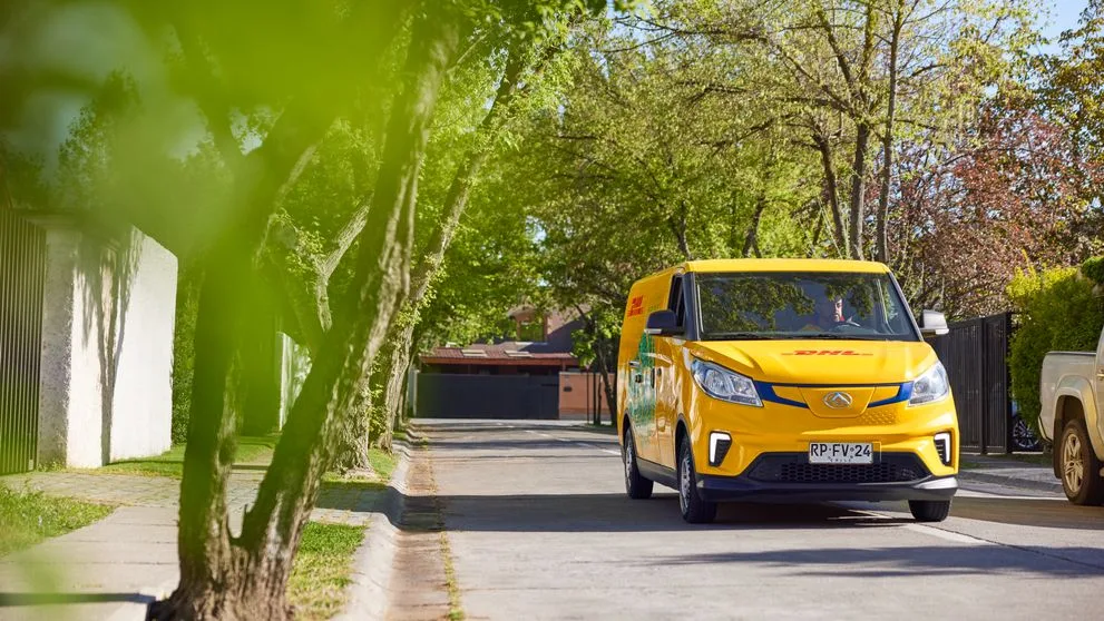 an electric dhl van making its delivery rounds