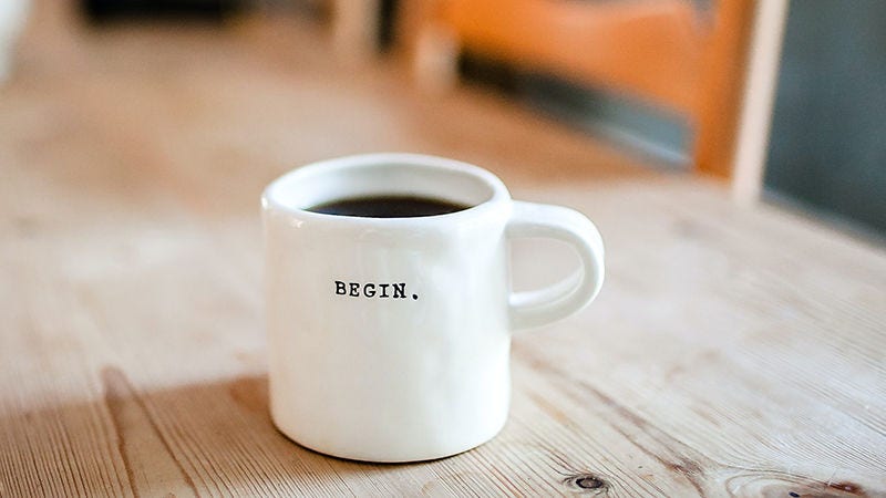 mug with begin written on it