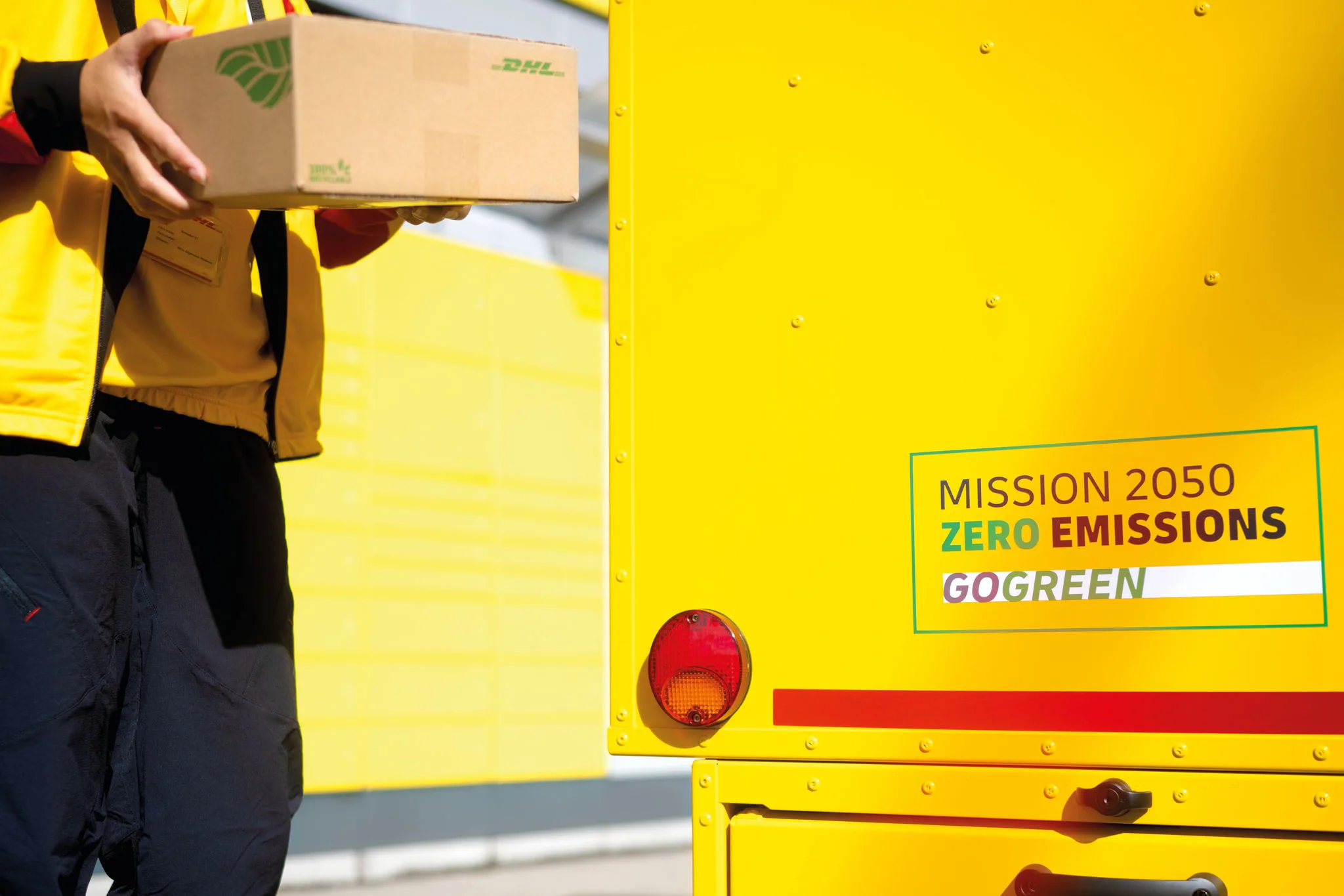 Employee carrying parcel in sustainable packaging 