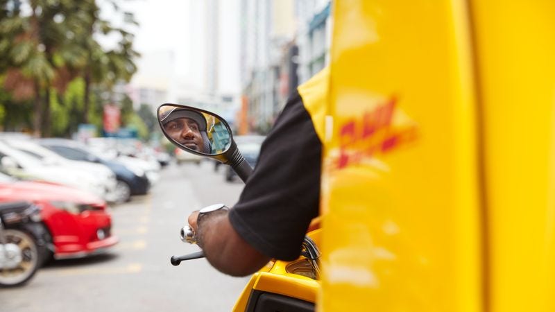 dhl express employee making a delivery on a scooter