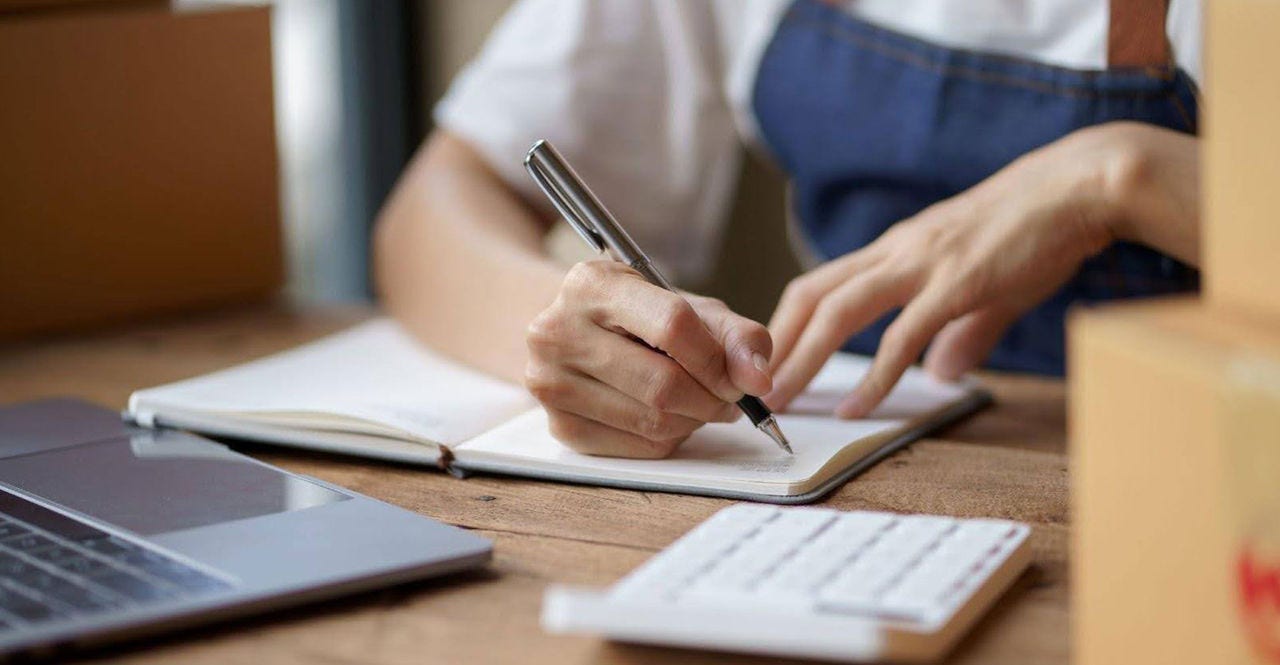 business owner calculating- dpp shipping charges from indonesia