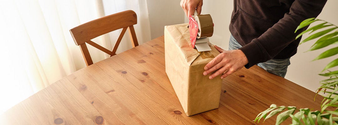 man wrapping parcel