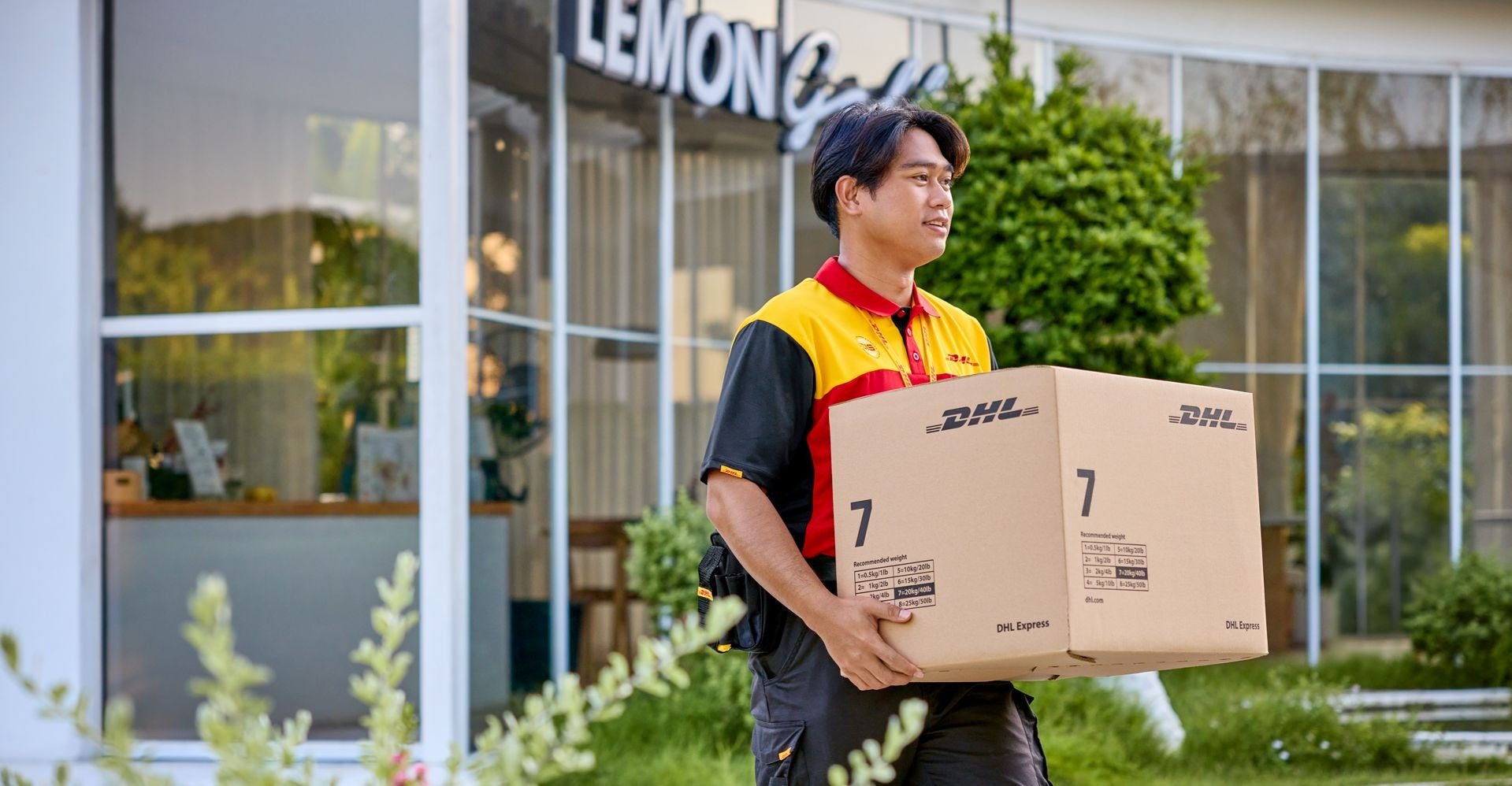 A DHL logistics employee delivering a parcel