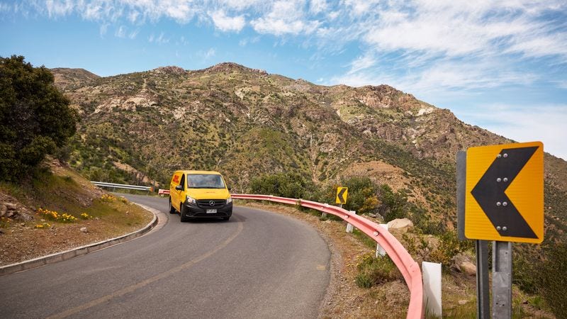 DHL van is driving through the mountainous landscape to make deliveries across countries