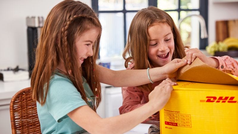 Two girls opening the packaging for an e-commerce product