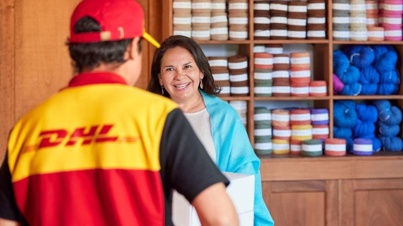 dhl staff picking up shipments from a shop