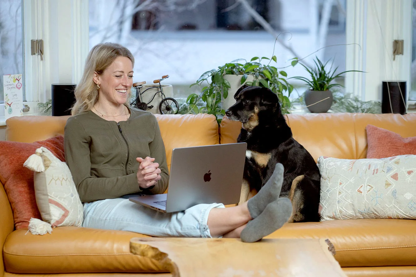 Kelsey working from home with her dog