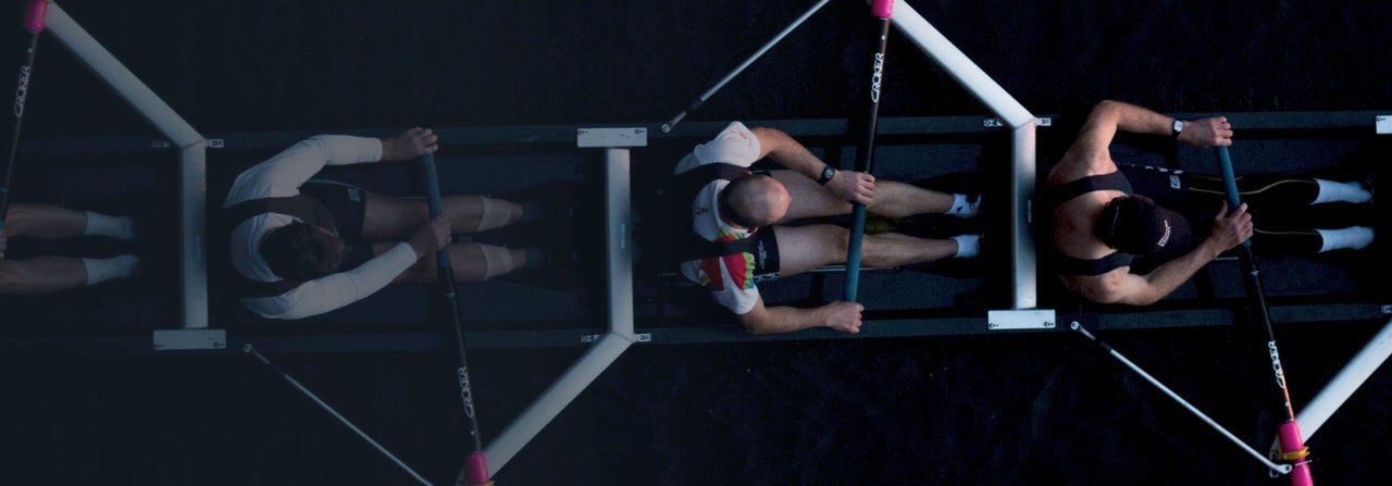 Birds eye view of men rowing in a rowing boat
