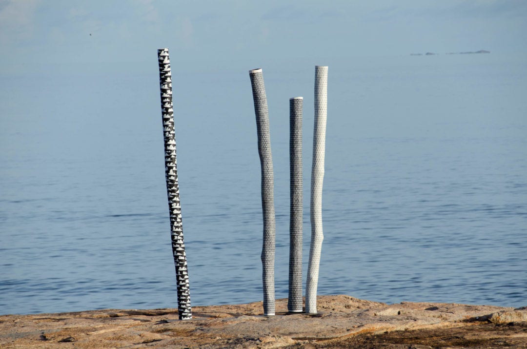 Wangupini Larrakitj (cloud motif on ceremonial poles) 2017 by Nawurapu Wunungmurra (c). Earth pigments on Stringybark hollow pole. Photo: Tim Acker. Courtesy Buku-Larrnggay Mulka Centre