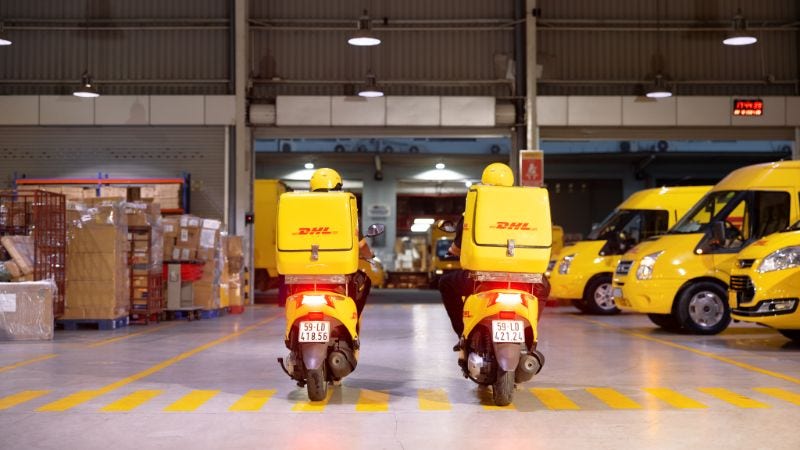 Two delivery motorbikes from dhl express vietnam side by side