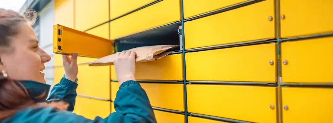 woman putting parcel in locker