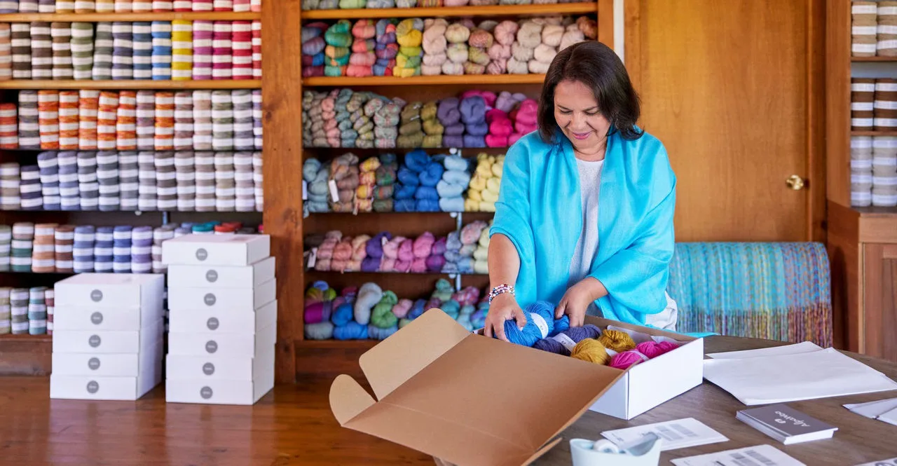 e-commerce business owner packing orders for shipment