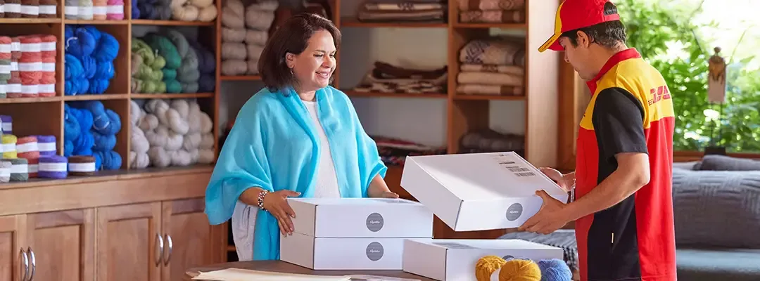 woman packing parcels with DHL courier